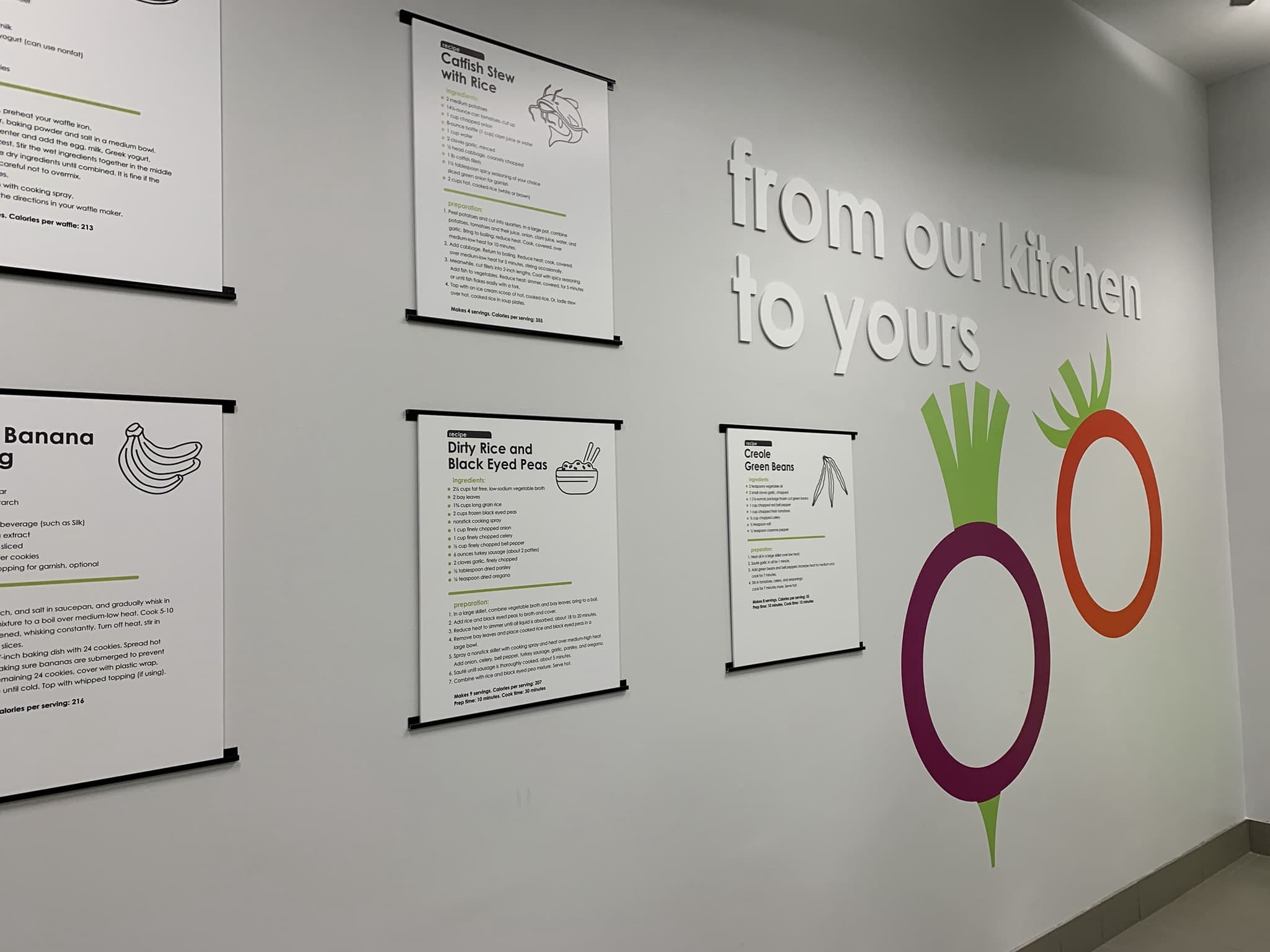 Wall with painted sign and printed recipes at Englewood Community Kitchens