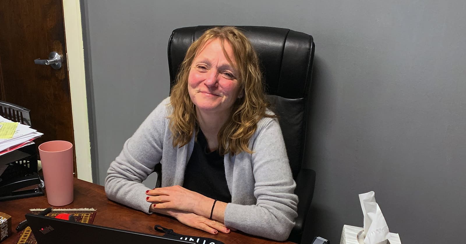 Kris Rittenmeyer sitting at desk in her office